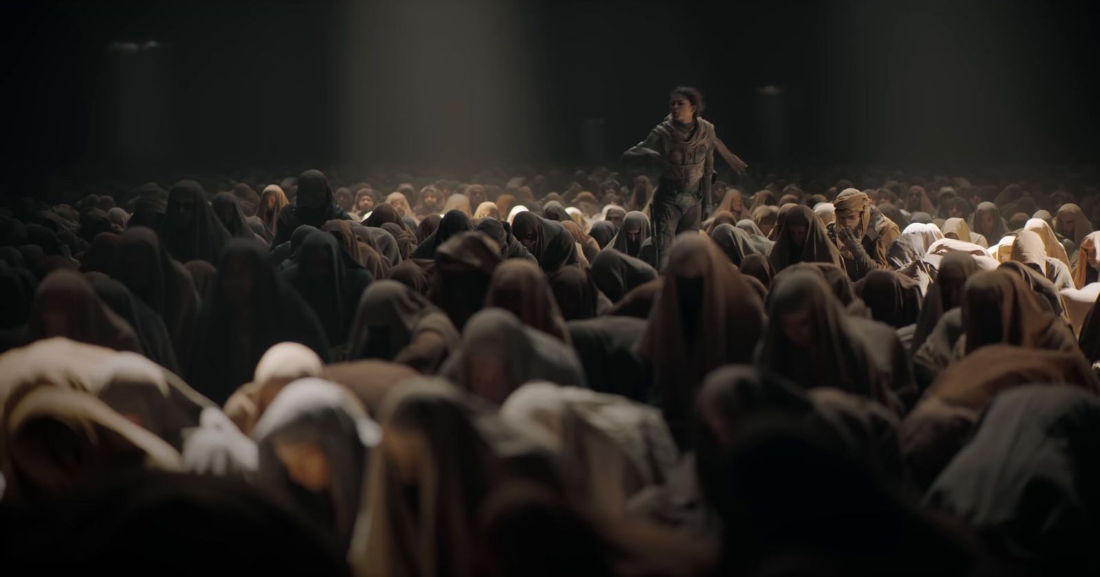 a large group of people in a dark room