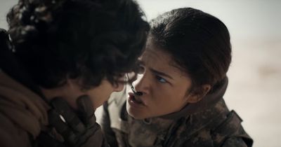 a woman in a military uniform talking to another woman