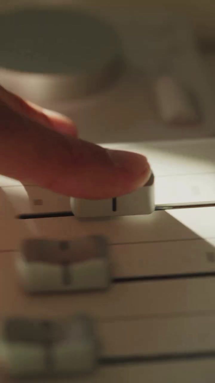 a close up of a person pressing buttons on a sound board