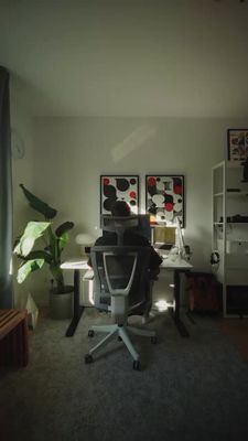 a person sitting at a desk in a room