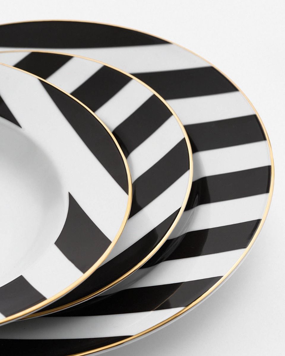 a stack of black and white plates sitting on top of each other