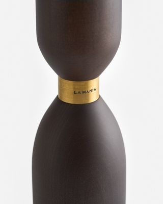 a brown vase with a gold band around it