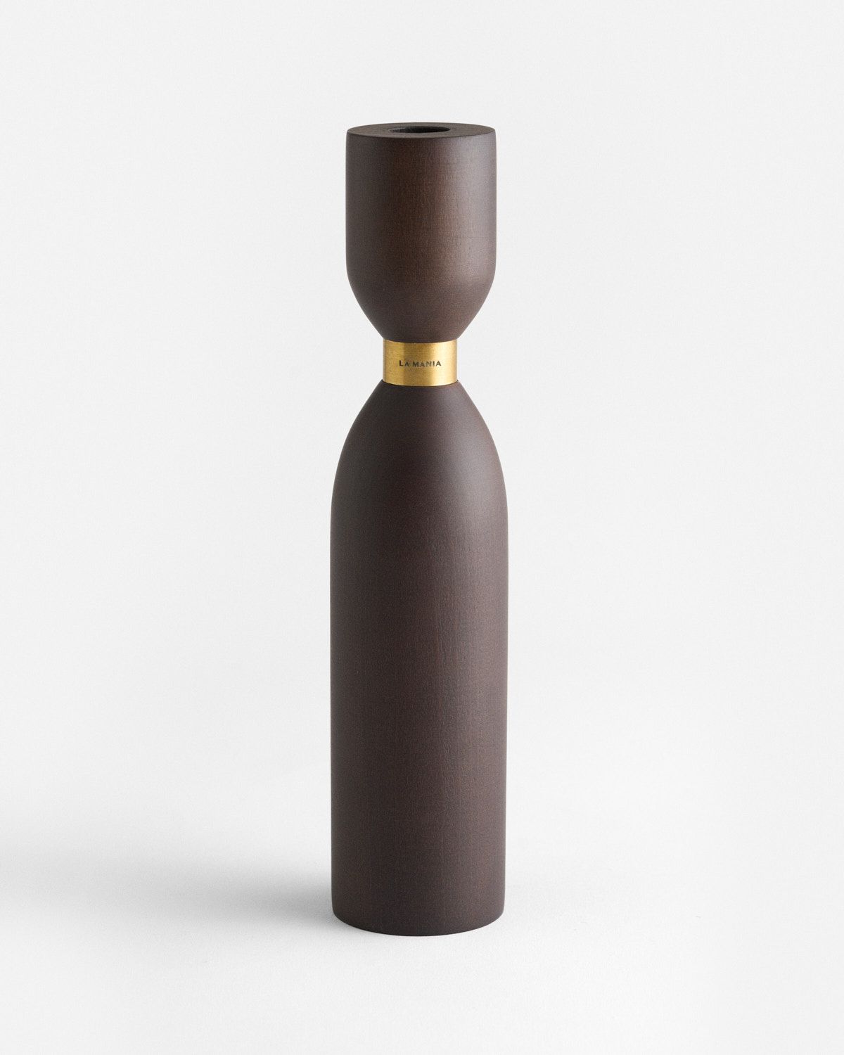 a brown vase sitting on top of a white table