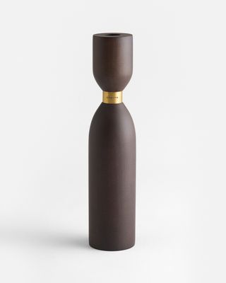 a brown vase sitting on top of a white table