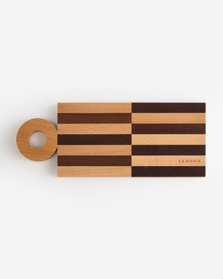 a wooden cutting board with a roll of tape