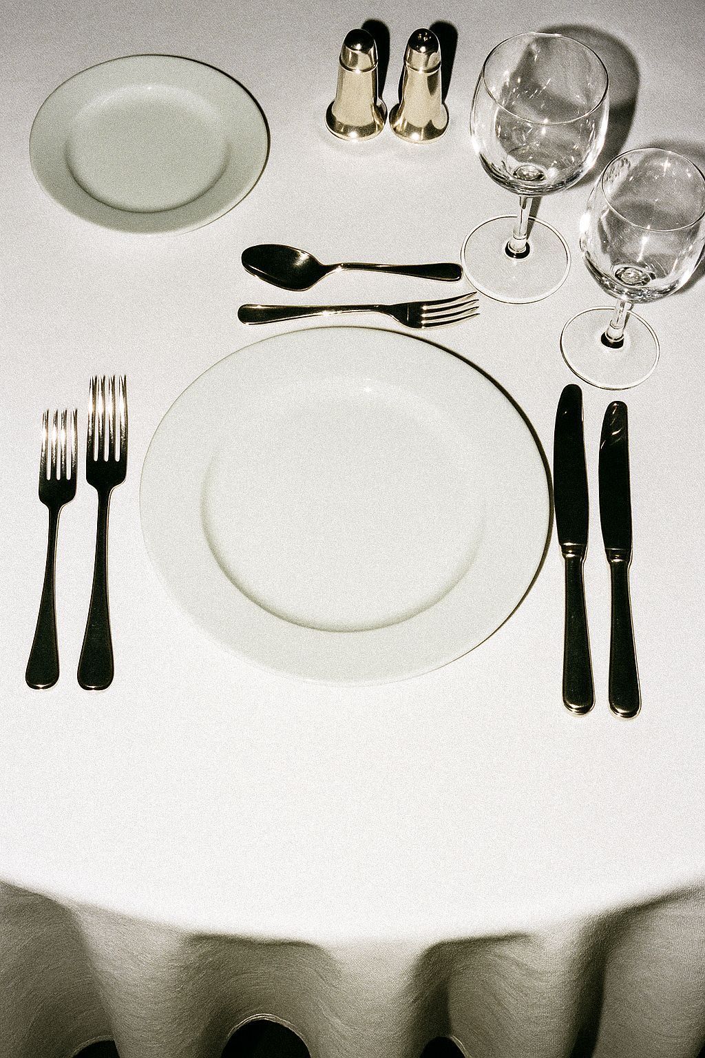 a table with a white table cloth and silverware