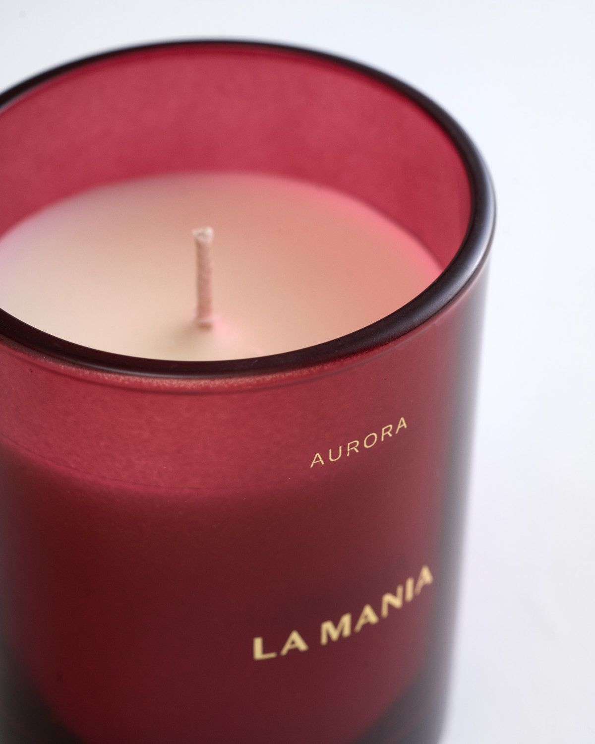 a red candle sitting on top of a white table