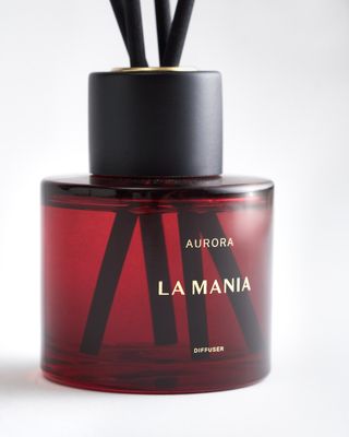 a bottle of perfume sitting on top of a white table