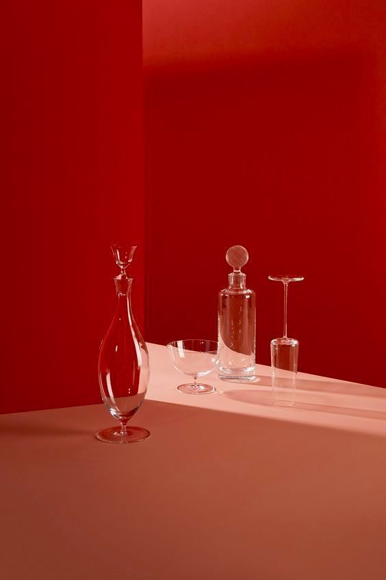 a red room with a white counter and a glass vase