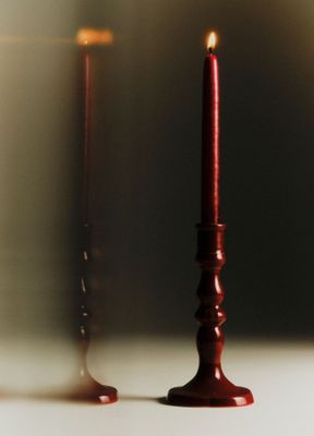 a candle that is next to a candle holder