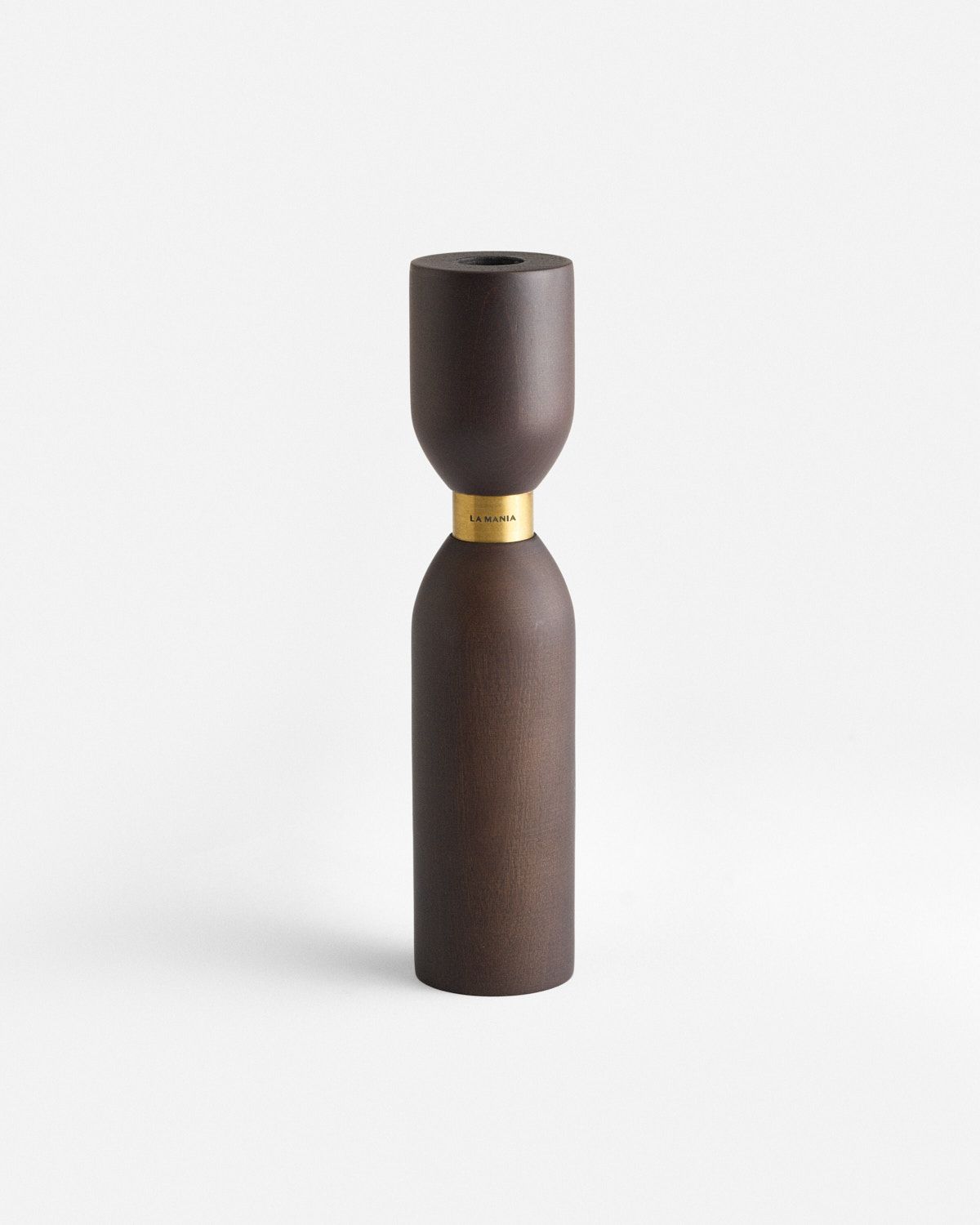 a brown vase sitting on top of a white table