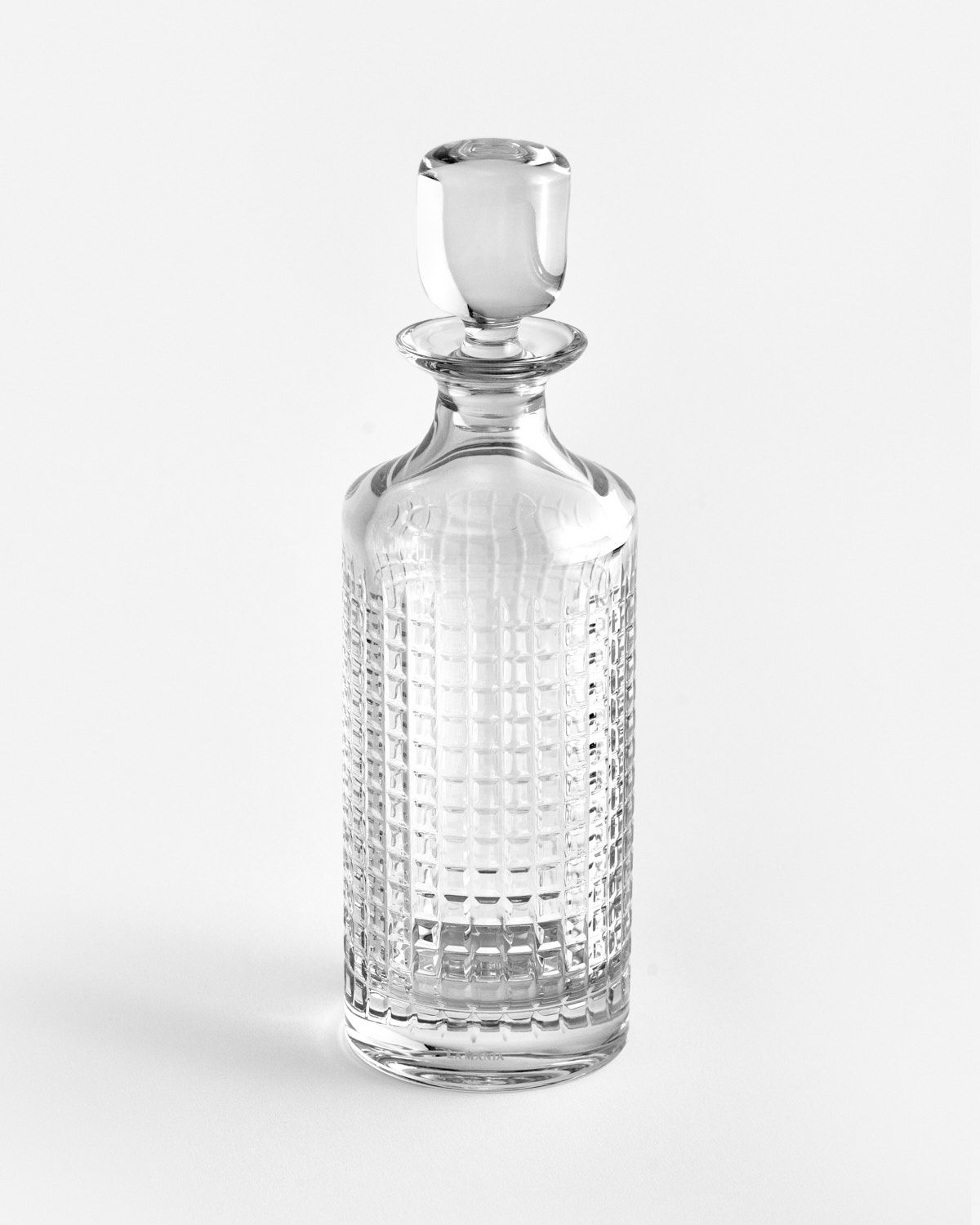 a clear glass bottle with a metal stopper