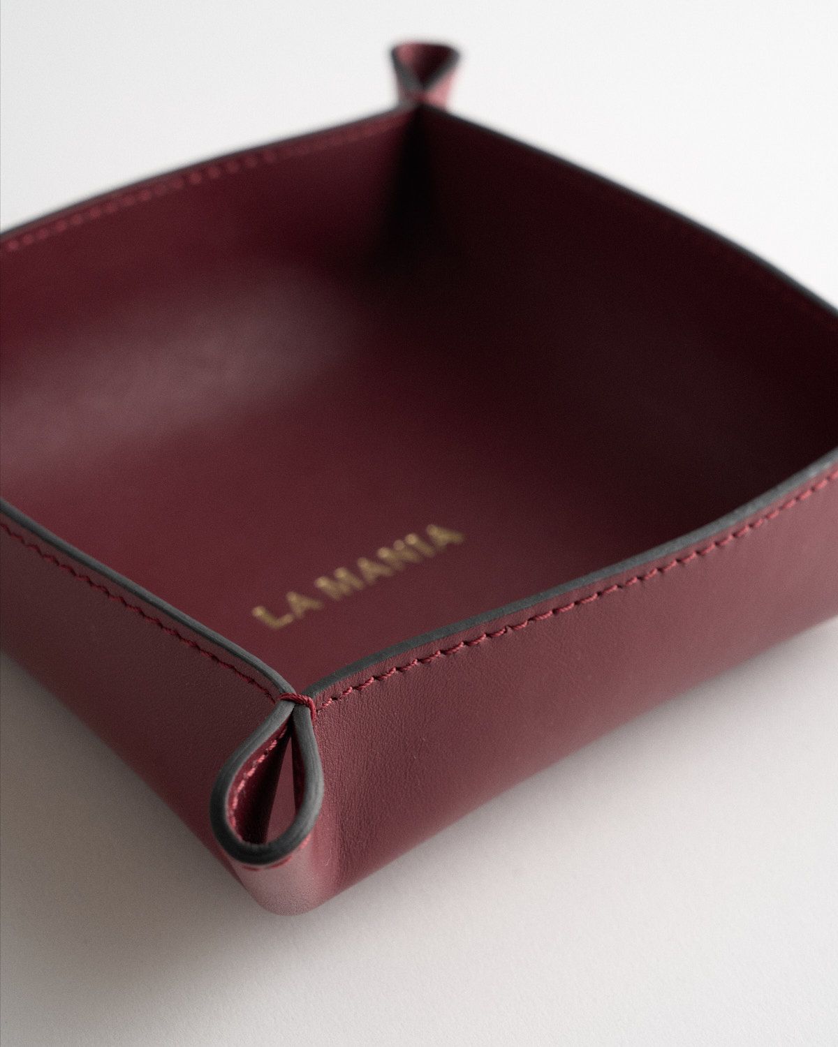 a red leather case sitting on top of a white table