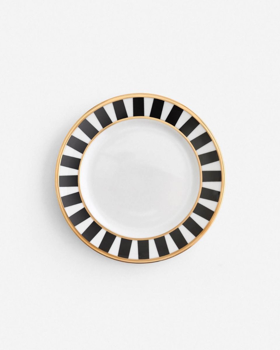 a black and white plate with gold trim