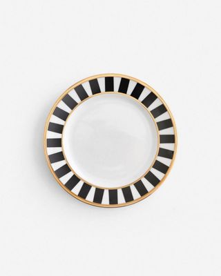 a black and white plate with gold trim