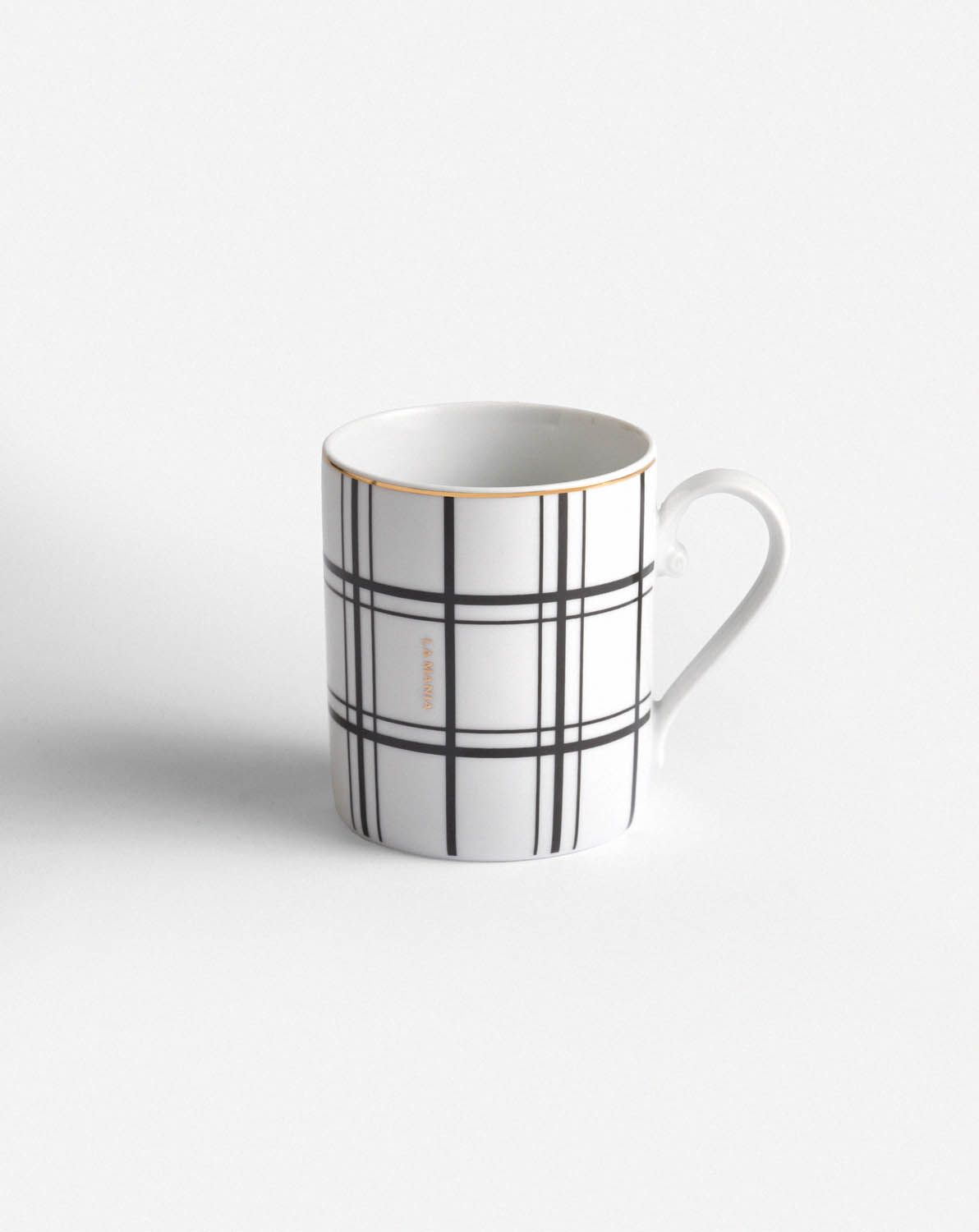 a black and white coffee cup on a white surface