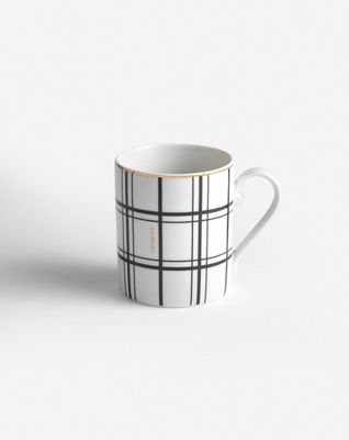 a black and white coffee cup on a white surface