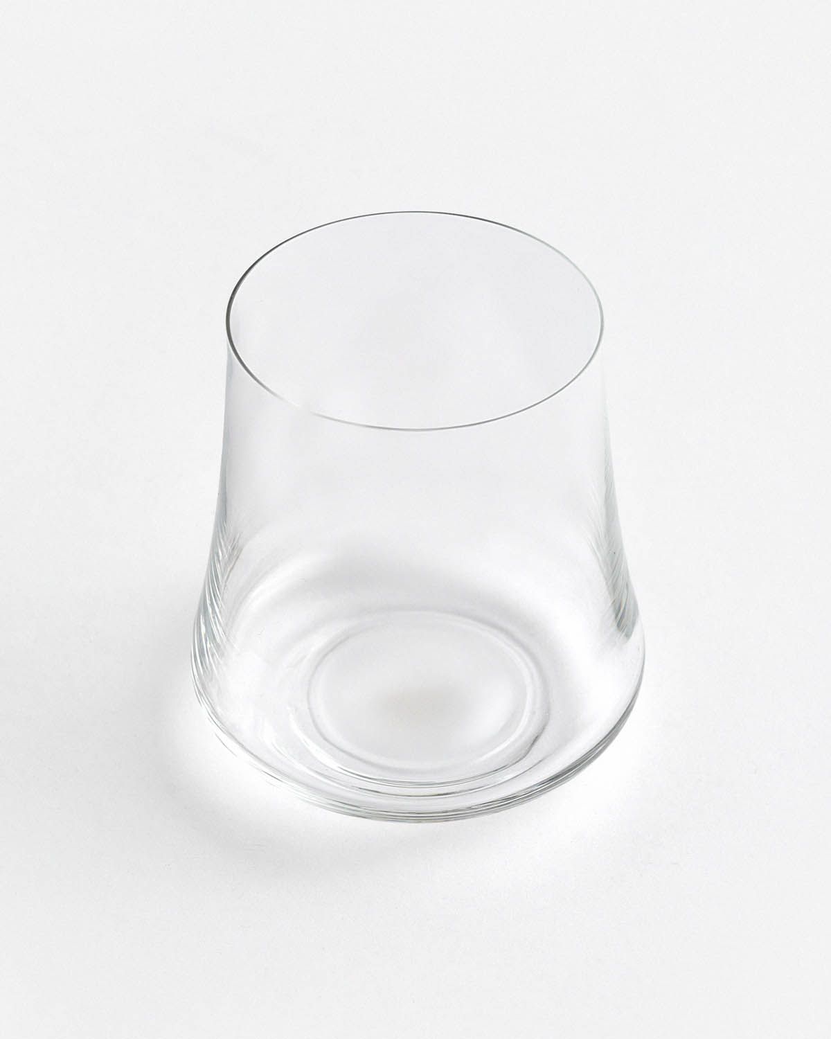 a clear glass sitting on top of a white table