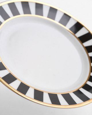 a black and white plate with a gold rim
