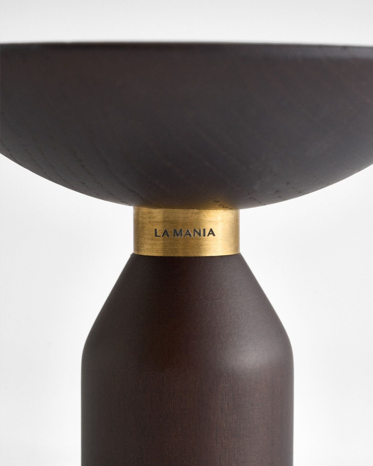 a brown vase with a gold lid on a white background
