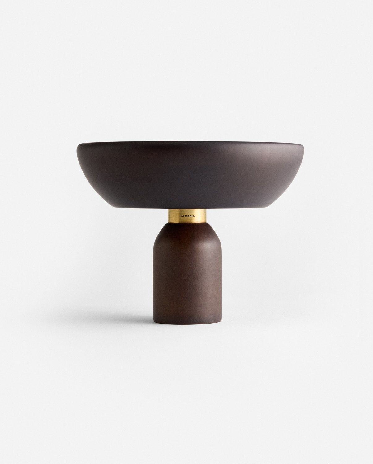 a brown bowl sitting on top of a wooden stand