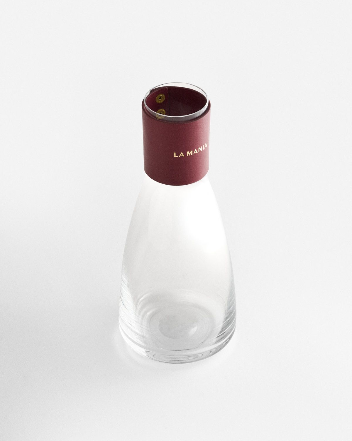 a small glass bottle with a red cap