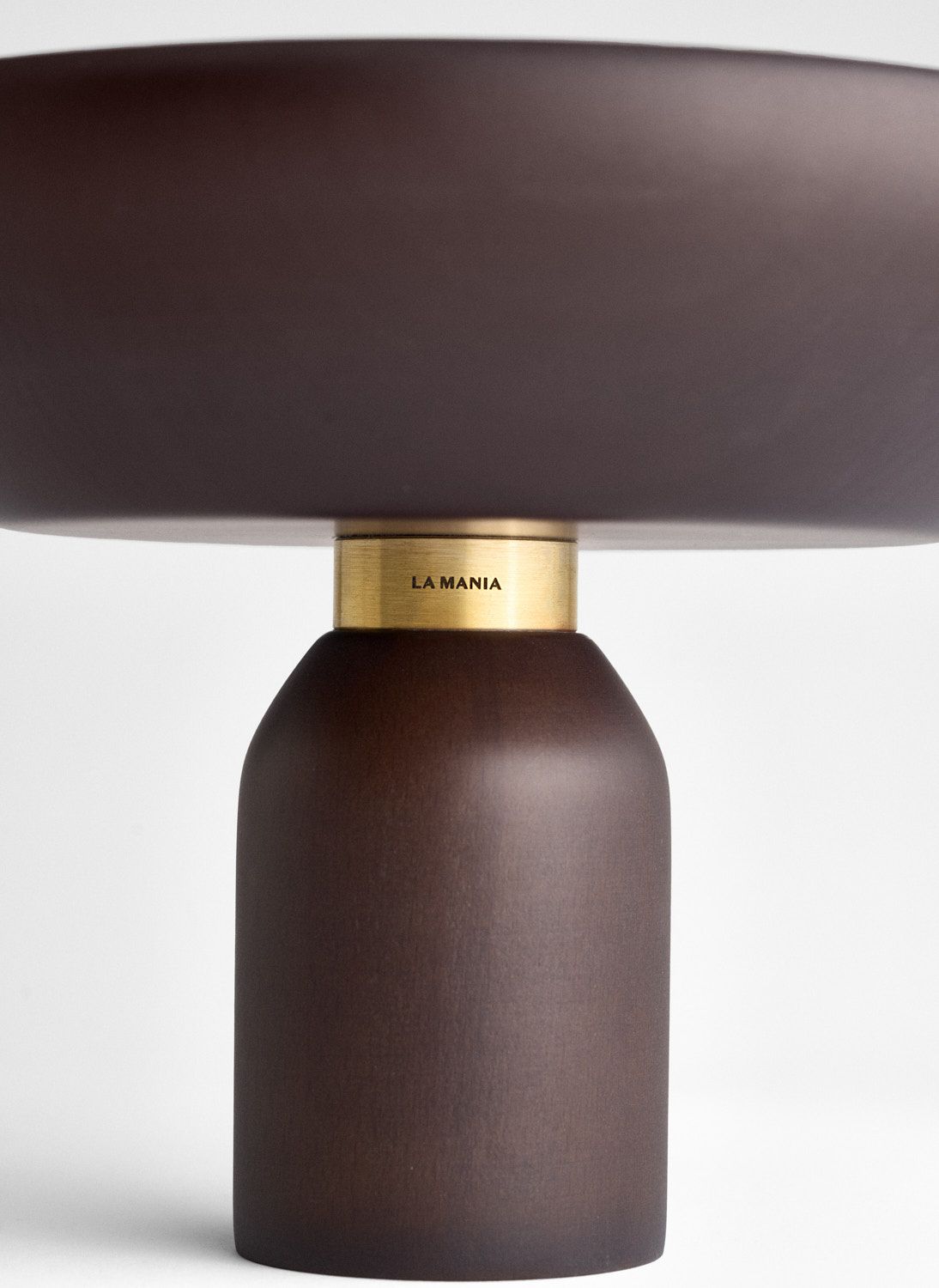 a table lamp with a brown shade on top of it