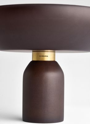 a table lamp with a brown shade on top of it