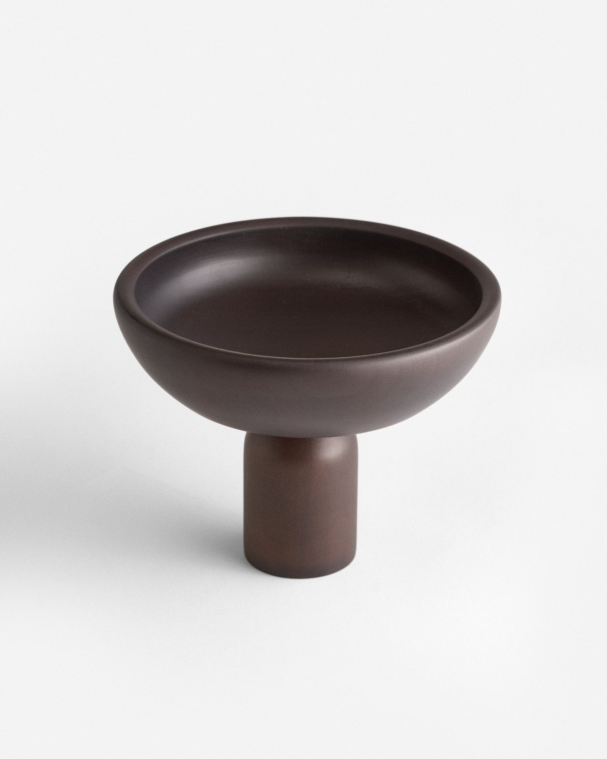 a brown bowl sitting on top of a table