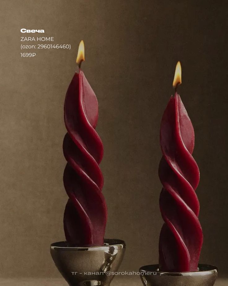 a couple of candles sitting on top of a table