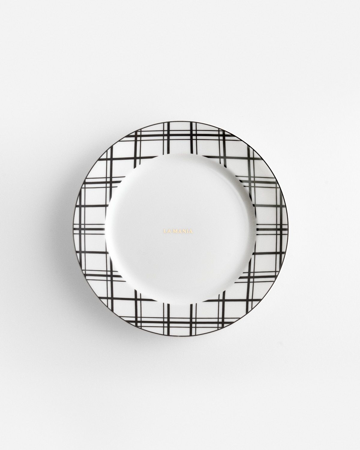 a white plate with a black and white check pattern