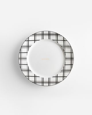 a white plate with a black and white check pattern