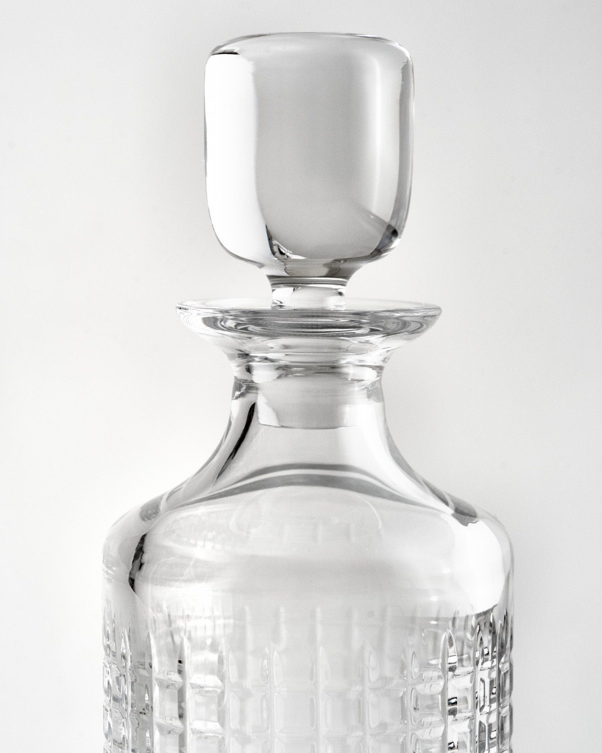 a clear glass bottle with a white background