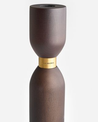 a brown vase with a gold top on a white background