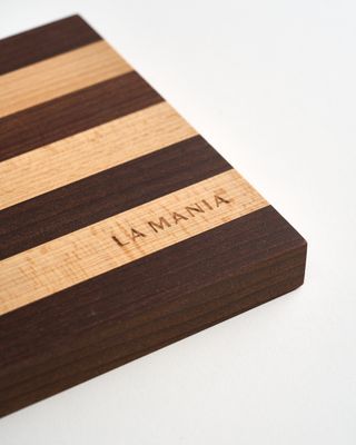 a wooden cutting board with a name on it