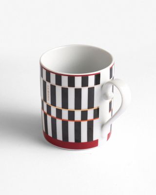 a black and white checkered coffee cup on a white background