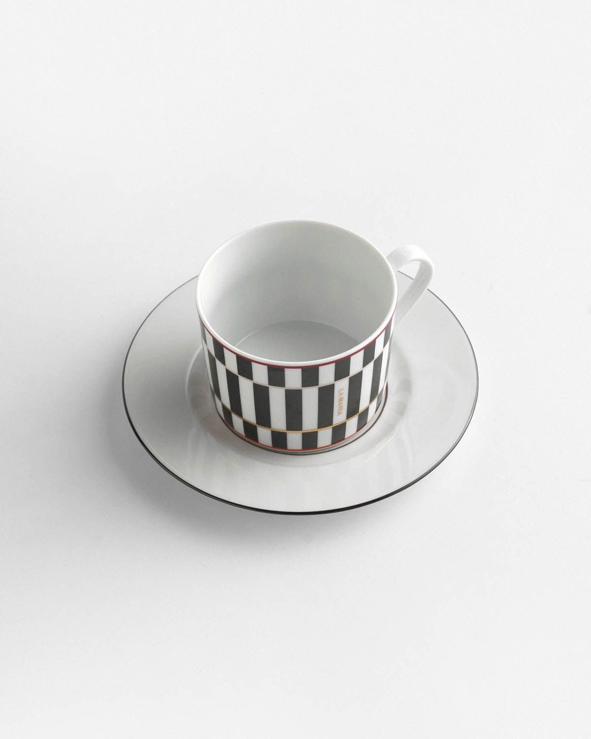 a black and white checkered cup and saucer