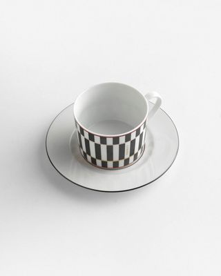 a black and white checkered cup and saucer