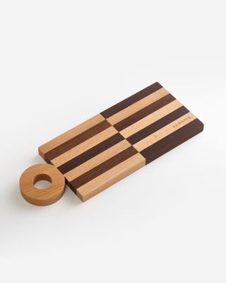 a wooden cutting board with a ring on it