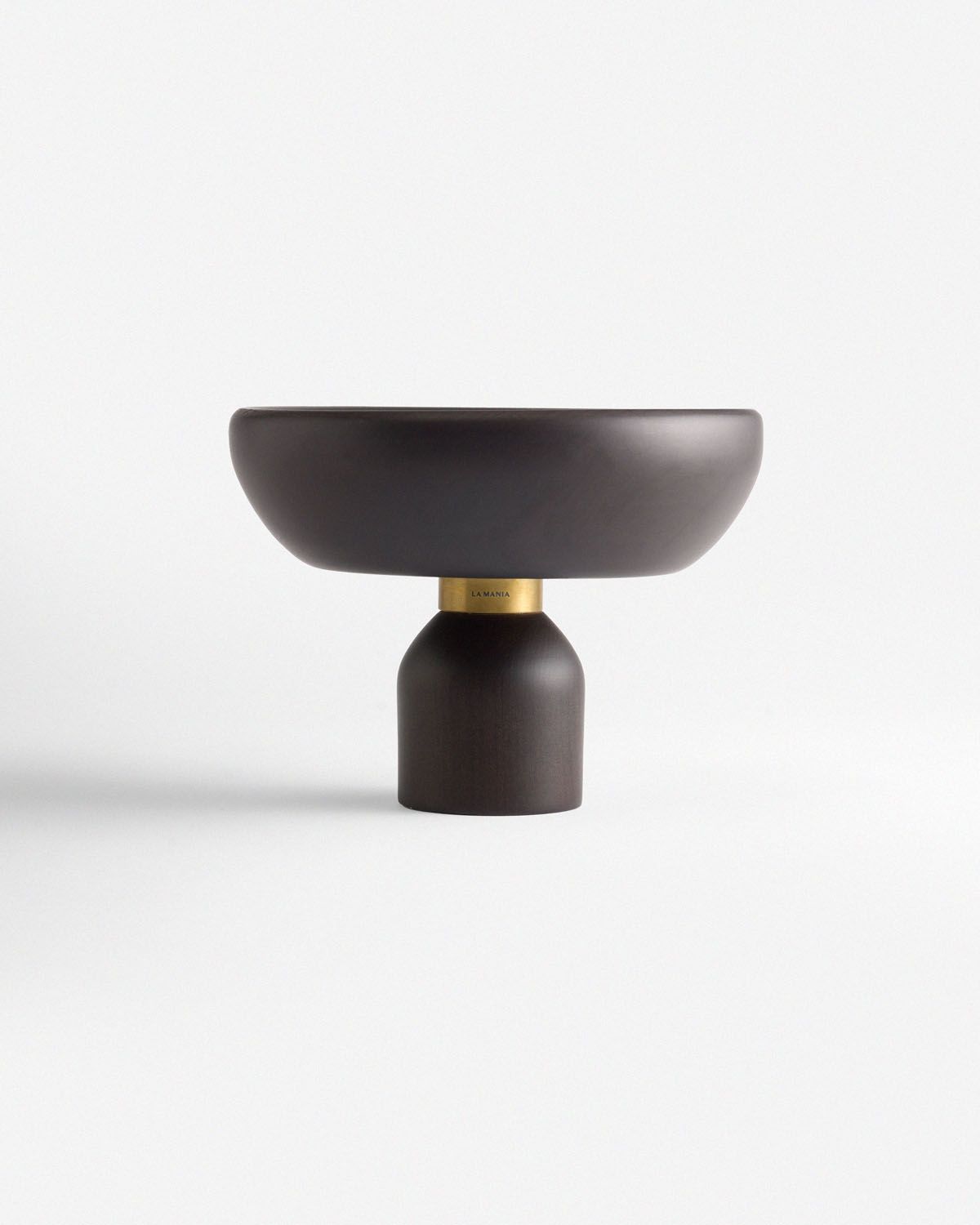 a black bowl sitting on top of a white table