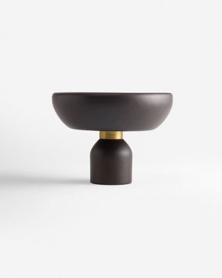 a black bowl sitting on top of a white table