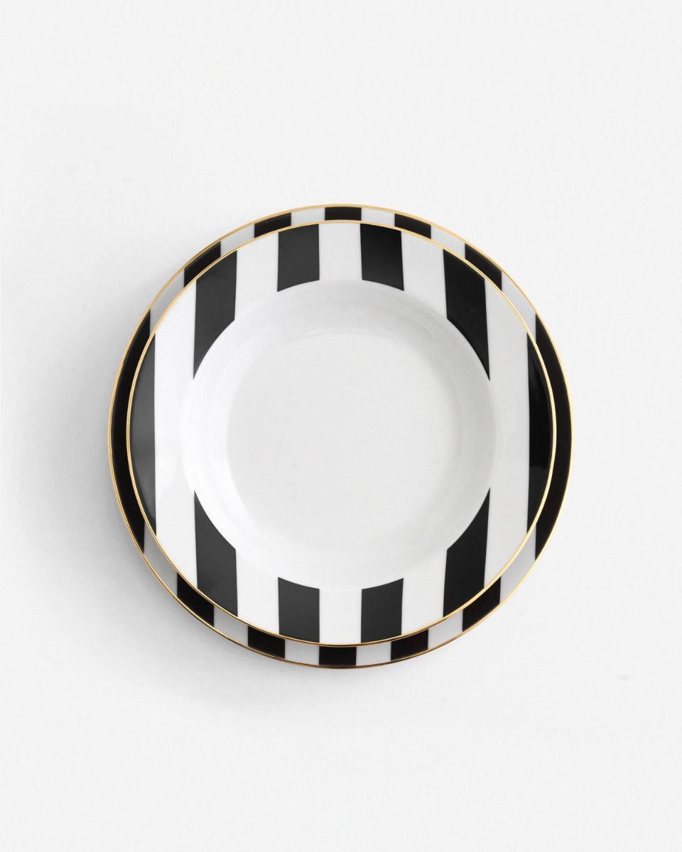 a black and white plate with gold trim