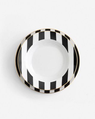 a black and white plate with gold trim