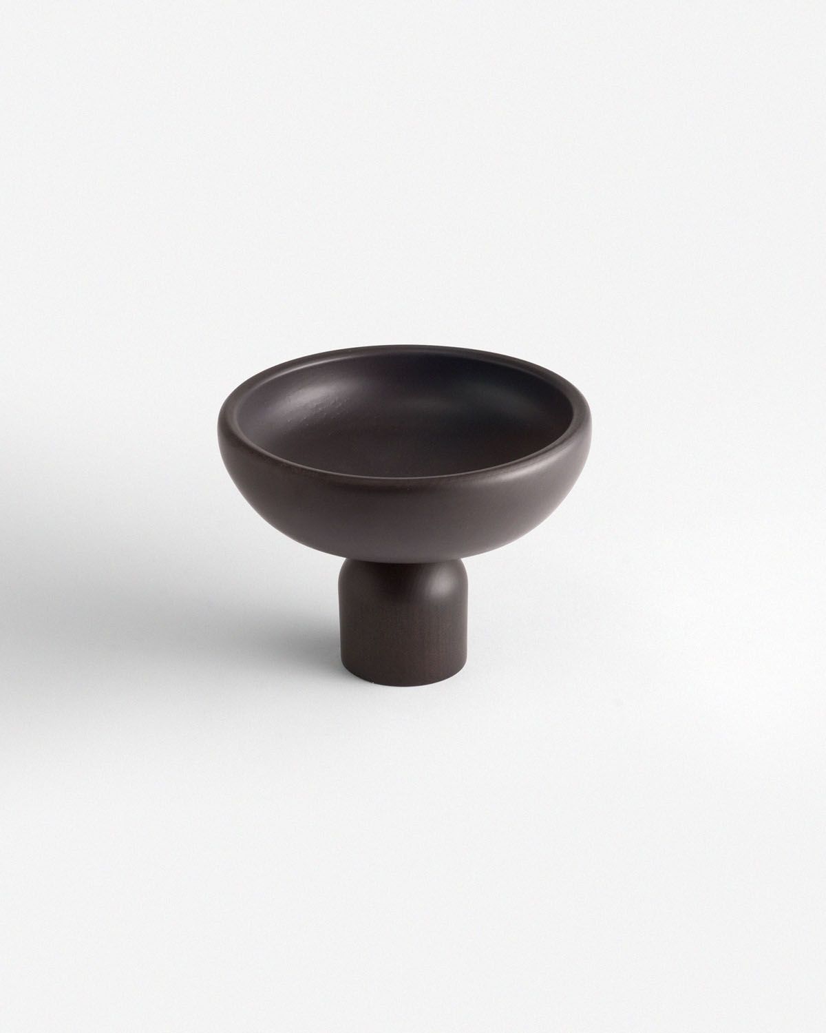a black bowl sitting on top of a white table