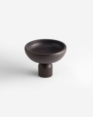 a black bowl sitting on top of a white table