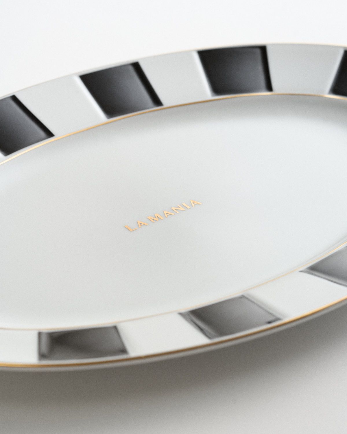 a white plate with black and gold lines on it