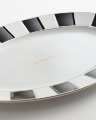 a white plate with black and gold lines on it
