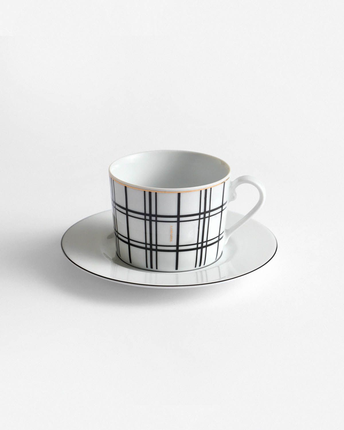 a black and white cup and saucer on a white background