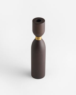 a brown bottle with a gold top on a white background