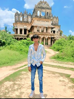 a man standing in front of an old building